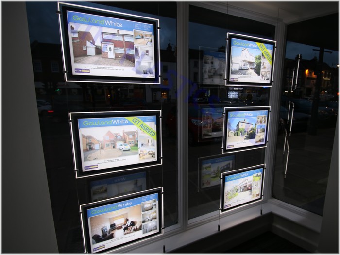 LED Pockets with illuminated borders in a letting agent's window