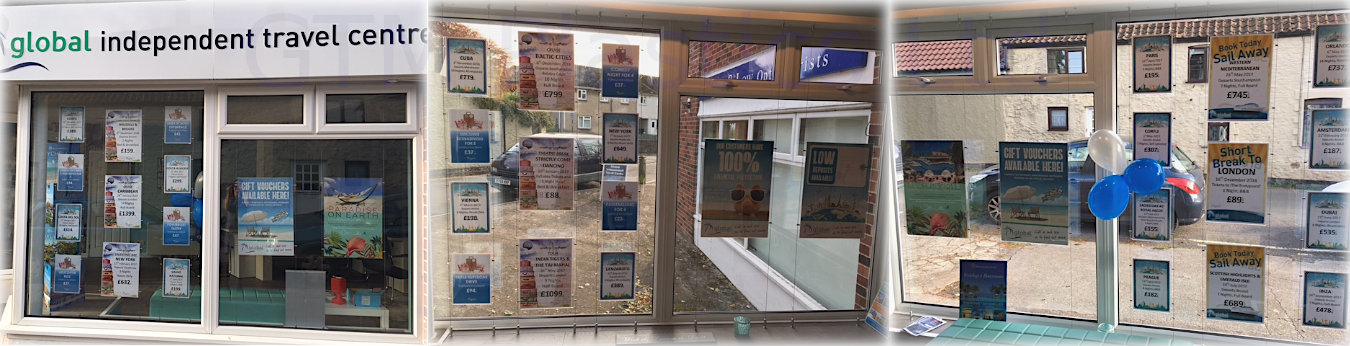 Acrylic pockets suspended between cables displaying posters in a travel agent's window