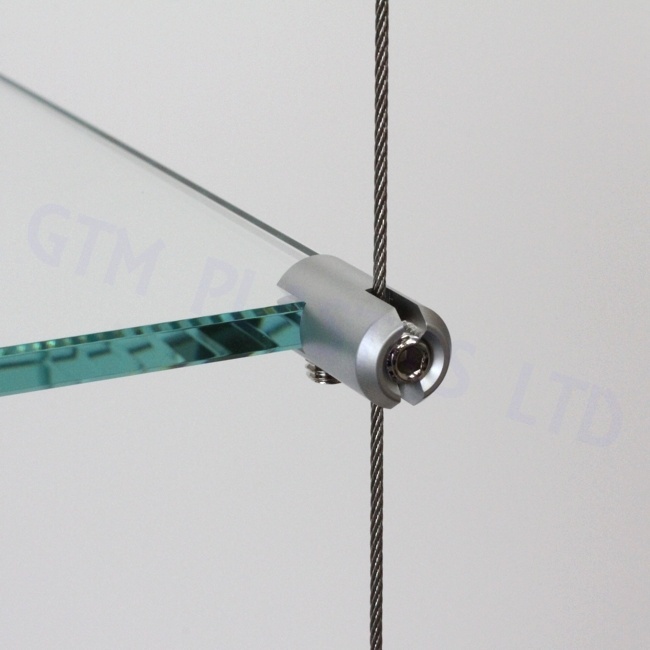Close up view of an anodised satin cable-to-shelf-clamp supporting a glass shelf panel