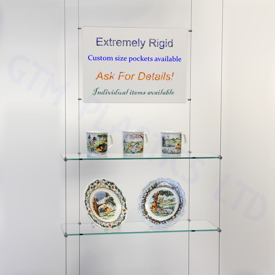 Glass wire suspended shelving displaying crockery with an optional poster holder between the cables
