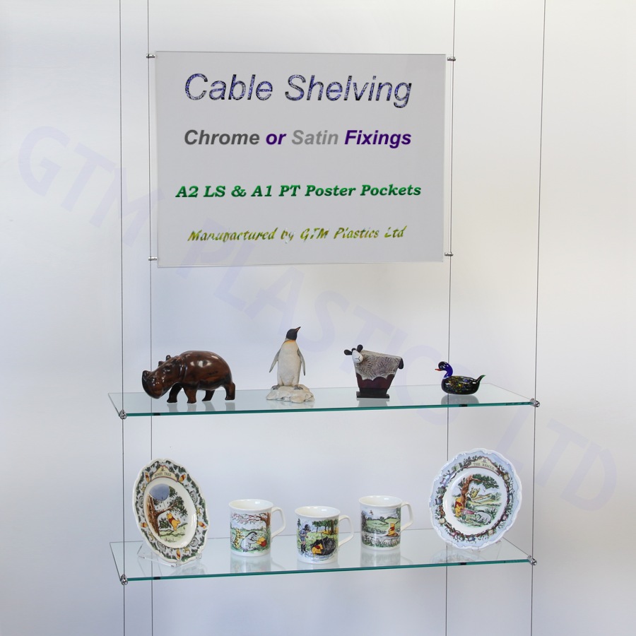 Glass wire suspended shelving displaying crockery with an optional poster holder between the cables